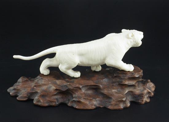 A Japanese ivory figure of a prowling tiger, signed Gyoku..? Meiji period, total length 23.5cm